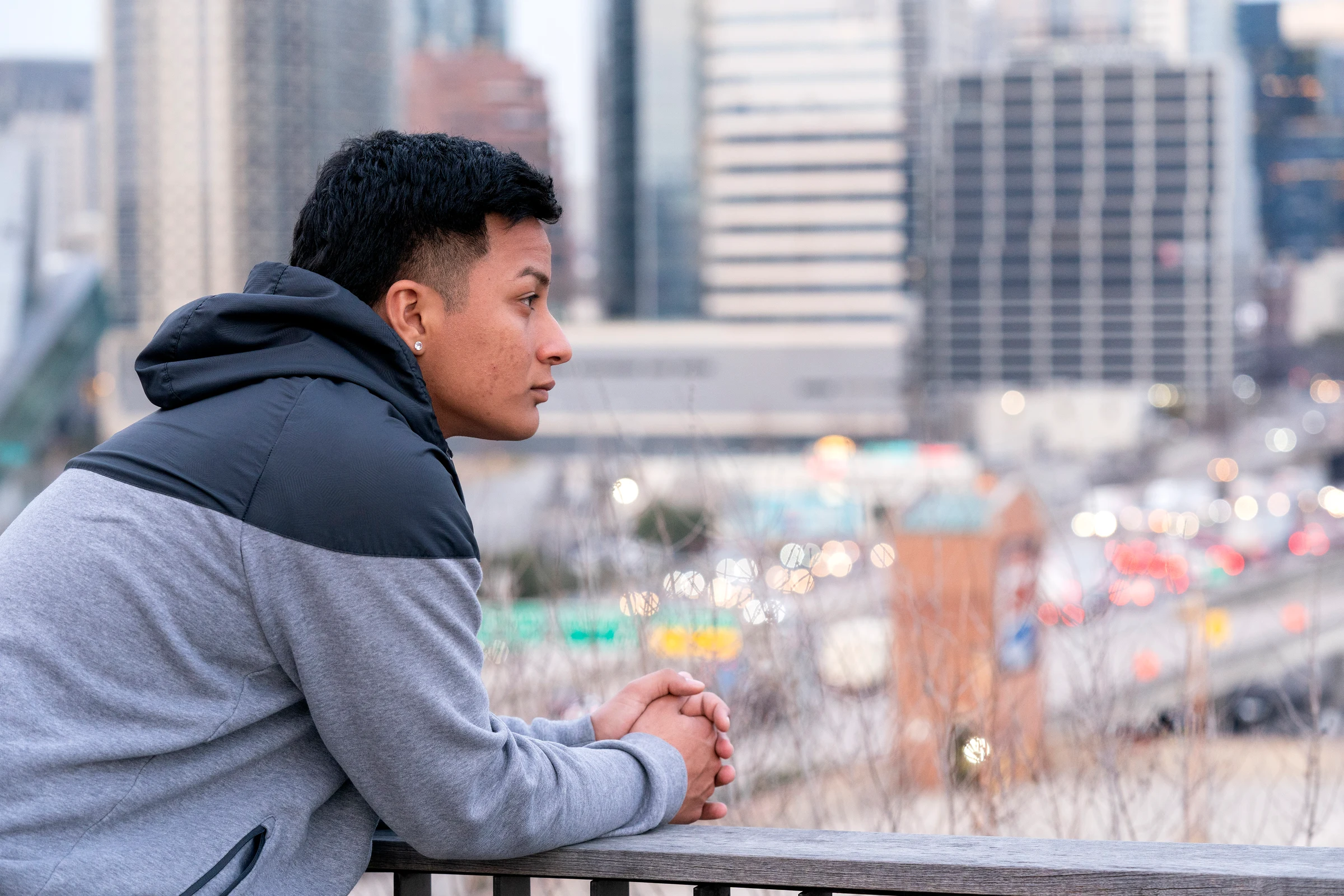 A young person looking out over the city