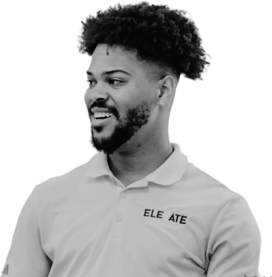 A smiling person wearing an Elevate polo